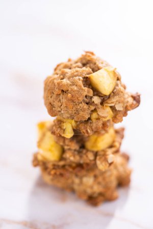 Photo for Stacked freshly baked apple oatmeal with apple chunks cookies. - Royalty Free Image