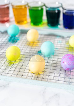 Photo for Easter egg coloring. Dye white organic eggs in different colors for Easter. - Royalty Free Image