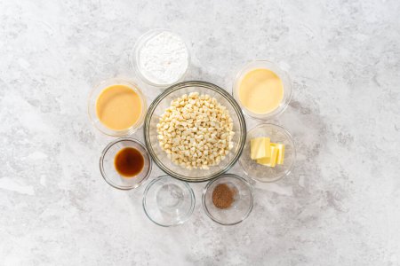Photo for Flat lay. Measured ingredients in glass mixing bowls to make eggnog fudge. - Royalty Free Image
