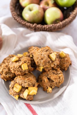 Photo for Freshly baked apple oatmeal with apple chunks cookies on small plate. - Royalty Free Image