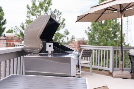 Photo for Outdoor six-burner gas grill on the back patio of a luxury single-family home. - Royalty Free Image