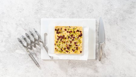 Photo for Flat lay. Storing cranberry pistachio fudge into the reusable plastic bag. - Royalty Free Image