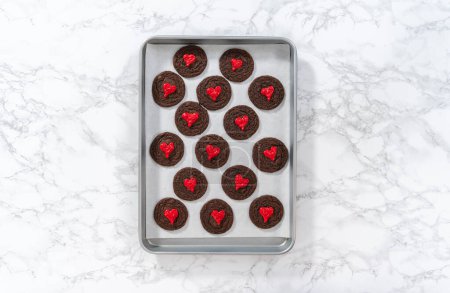 Téléchargez les photos : Pose plate. Décorer les biscuits au chocolat avec des coeurs de chocolat rouge. - en image libre de droit