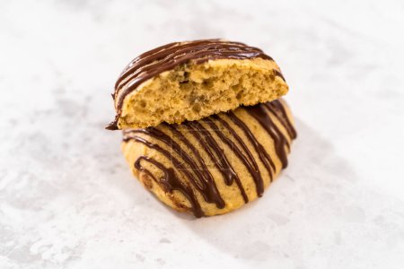 Photo for Freshly baked banana cookies with chocolate drizzle on a white ceramic plate. - Royalty Free Image