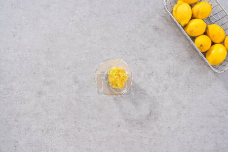 Photo for Flat lay. Mixing ingredients in a glass mixing bowl to prepare lemon cranberry bundt cake. - Royalty Free Image