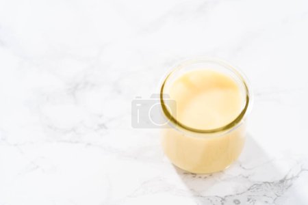 Téléchargez les photos : Ganache au chocolat blanc dans un petit bocal en verre maçon. - en image libre de droit