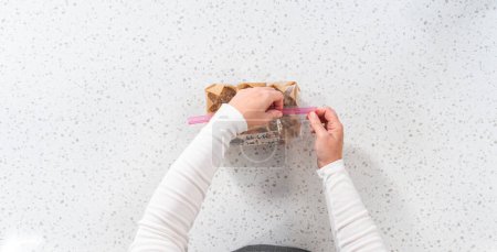 Photo for Flat lay. Meal prepping. Packaging banana oatmeal muffins into the plastic back to store in a freezer. - Royalty Free Image