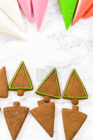 Téléchargez les photos : Décorer les biscuits au pain d'épice de Noël avec glaçage royal. - en image libre de droit