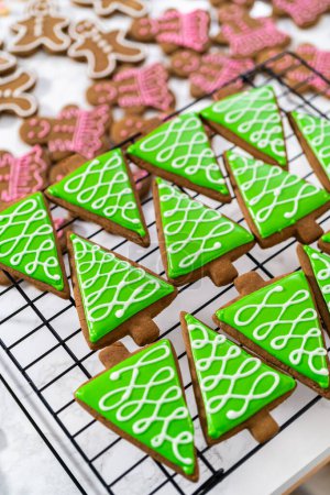 Photo for Decorating Christmas gingerbread cookies with royal icing. - Royalty Free Image