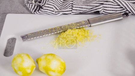 Photo for Zesting organic lemons to bake a lemon pound cake. - Royalty Free Image