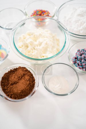 Photo for Measured ingredients in glass mixing bowls to make unicorn hot chocolate mix. - Royalty Free Image