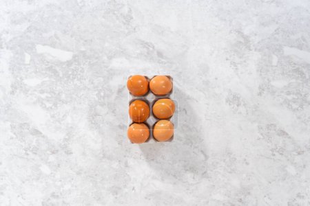 Photo for Flat lay. Hard-boiled eggs in a white ceramic egg crate. - Royalty Free Image