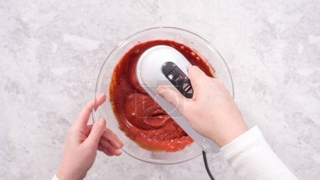 Photo for Flat lay. Step by step. Mixing ingredients in a glass mixing bowl to prepare red velvet bundt cake. - Royalty Free Image