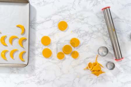 Photo for Flat lay. Lemon wedge cookies with lemon glaze. Rolling cookie dough with an adjustable rolling pin and cutting out cookies with cookie cutters to bake lemon wedge cookies with lemon glaze. - Royalty Free Image