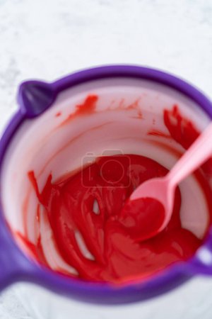 Photo for Melting color chocolate chips in electric candy melting pot. - Royalty Free Image