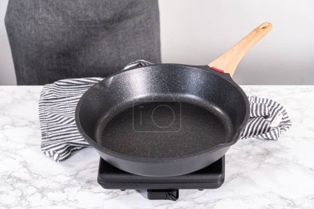 Photo for Frying mini pancake cereal in a nonstick frying pan. - Royalty Free Image