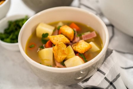 Téléchargez les photos : Servir de la soupe aux pois cassés dans des bols à soupe en céramique. - en image libre de droit