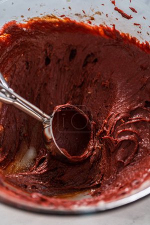 Téléchargez les photos : Remplir la casserole à gâteau en métal avec du beurre à gâteau pour cuire le gâteau bundt en velours rouge avec glaçage au fromage à la crème - en image libre de droit