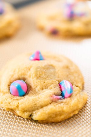 Photo for Freshly baked unicorn chocolate chip cookies on a baking sheet lined with a silicone mat. - Royalty Free Image