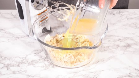 Photo for Step by step. Mixing ingredients for mini pancake cereal in a glass mixing bowl. - Royalty Free Image