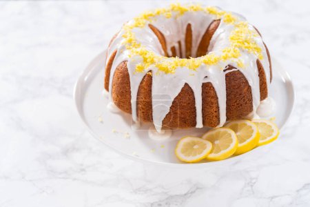 Foto de Tarta de limonada decorada con ralladura de limón en un soporte de pastel. - Imagen libre de derechos