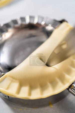 Photo for Filling empanada dough with blueberry pie filling to make sweet empanadas with blueberries. - Royalty Free Image