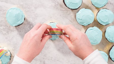 Photo for Flat lay. Step by step. Decorating chocolate cupcakes with buttercream frosting and rainbow candy. - Royalty Free Image
