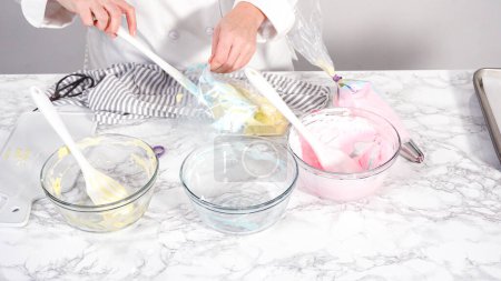 Photo for Step by step. Mixing food coloring into the meringue to bake unicorn meringue cookies. - Royalty Free Image