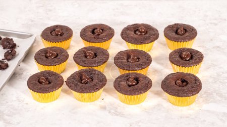 Photo for Step by step. Filling in chocolate cupcakes with chocolate ganache. - Royalty Free Image