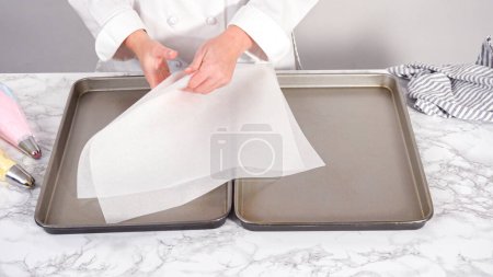 Téléchargez les photos : Pas à pas. Tuyauterie biscuits meringue licorne à la plaque de cuisson doublée d'un papier parchemin. - en image libre de droit