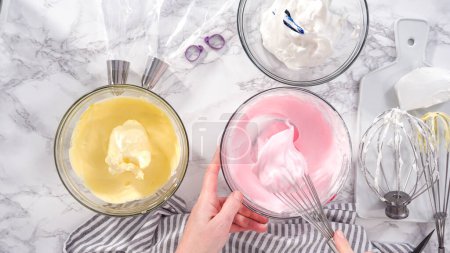 Photo for Step by step. Flat lay. Mixing food coloring into the meringue to bake unicorn meringue cookies. - Royalty Free Image