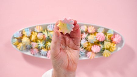 Photo for Step by step. Flat lay. Multicolored unicorn meringue cookies on a white serving plate. - Royalty Free Image