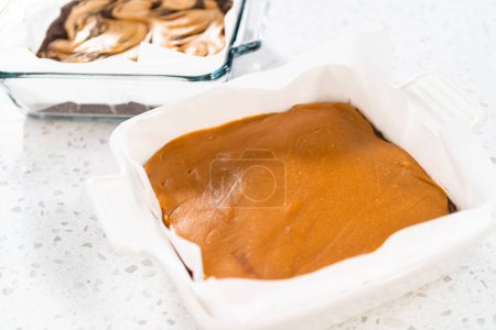 Photo for Variety of homemade fudge in square baking pans lined with parchment paper. - Royalty Free Image