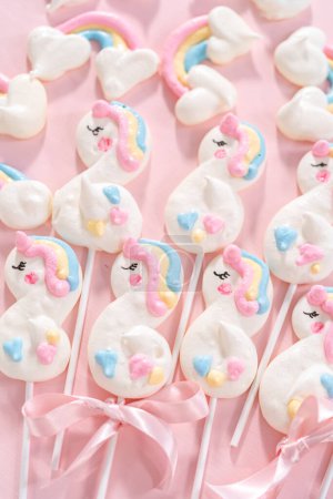 Photo for Gourmet unicorn theme meringue pops on a pink background. - Royalty Free Image