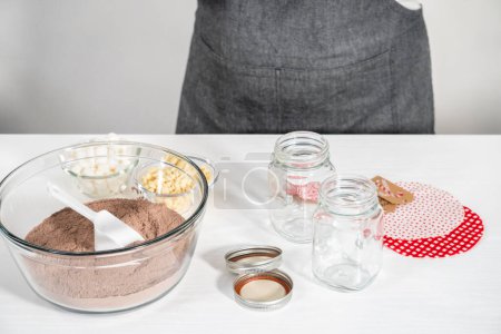 Photo for Making homemade hot chocolate mix in drinking mason jar for Christmas food gift. - Royalty Free Image