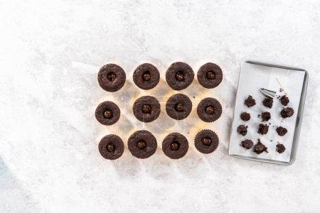 Photo for Flat lay. Filling in chocolate cupcakes with chocolate ganache. - Royalty Free Image