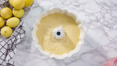 Photo for Step by step. Flat lay. Lemon pound cake batter in a baking bundt pan ready to be baked. - Royalty Free Image