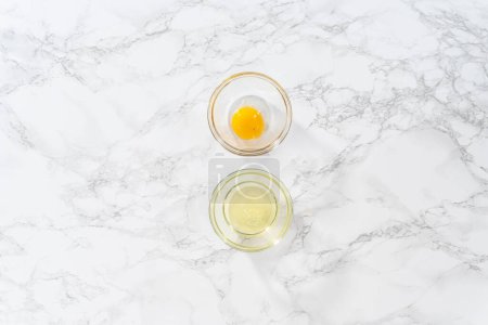 Photo for Flat lay. Separating egg whites and egg yolks into small bowls. - Royalty Free Image