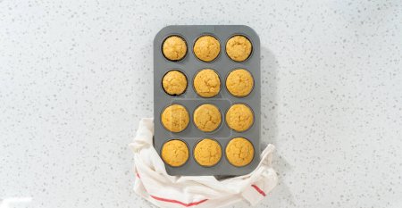 Photo for Flat lay. Cooling freshly baked dulce de leche cupcakes on a kitchen counter. - Royalty Free Image