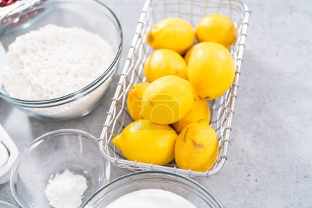 Téléchargez les photos : Ingrédients dans des bols à mélanger en verre pour préparer le gâteau bundt aux canneberges au citron. - en image libre de droit