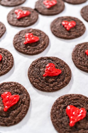 Foto de Decoración de galletas de chocolate con corazones de chocolate rojo. - Imagen libre de derechos