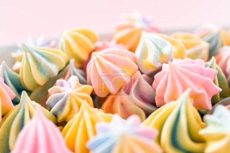 Photo for Multicolored unicorn meringue cookies on a white serving plate. - Royalty Free Image