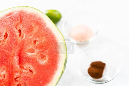 Photo for Measured ingredients in a small glass mixing bowl to prepare chili lime watermelon pops. - Royalty Free Image