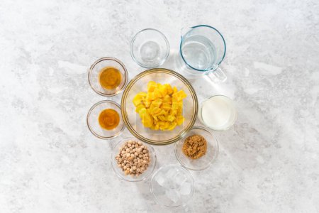 Photo for Flat lay. Measured ingredients in glass mixing bowls to prepare mango boba smoothie. - Royalty Free Image