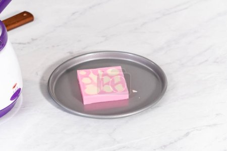 Téléchargez les photos : Remplissage de moules en silicone au chocolat fondu pour préparer des mini barres de chocolat sirène. - en image libre de droit