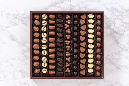 Photo for Flat lay. Box of gourmet assorted chocolates ina large box. - Royalty Free Image