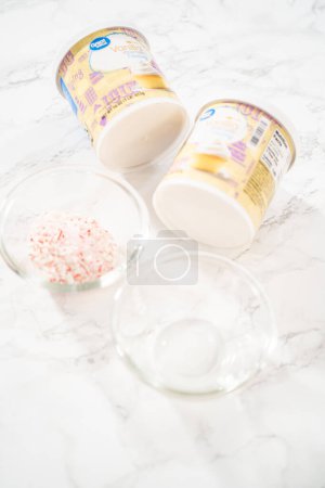 Photo for Denver, Colorado, USA-December 18, 2021 - Measured ingredients in a glass mixing bowl to prepare peppermint buttercream frosting. - Royalty Free Image
