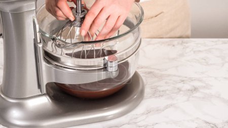 Photo for Step by step. Whipping chocolate ganache with an electric kitchen mixer. - Royalty Free Image