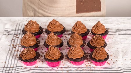 Téléchargez les photos : Pas à pas. Barre de chocolat à raser sur des cupcakes au chocolat givré avec glaçage à la ganache au chocolat. - en image libre de droit