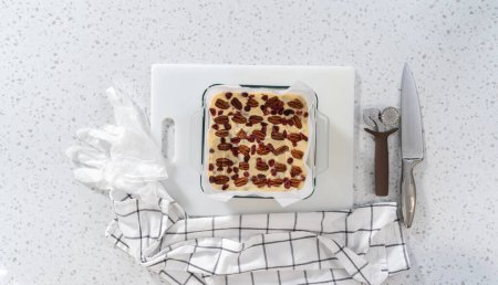 Photo for Flat lay. Scoring white chocolate cranberry pecan fudge for cutting into small pieces. - Royalty Free Image